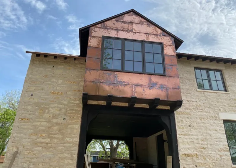 Copper metal panel facade on a stone building for Skylight Installation in Cedar Mill